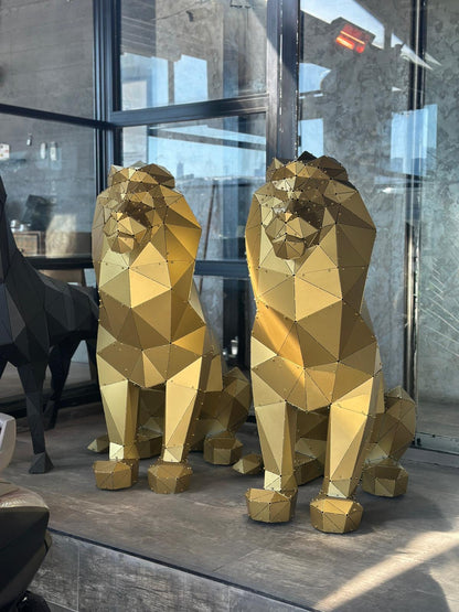 Two luxury gold geometric lion sculptures handcrafted from metal.