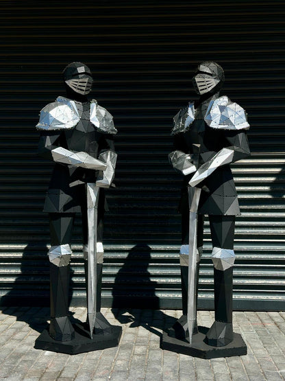 Two luxury handcrafted metal sculptures of armored knights with swords
