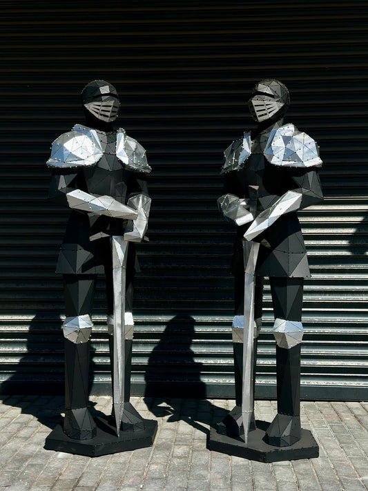Two luxury handcrafted metal sculptures of armored knights with swords