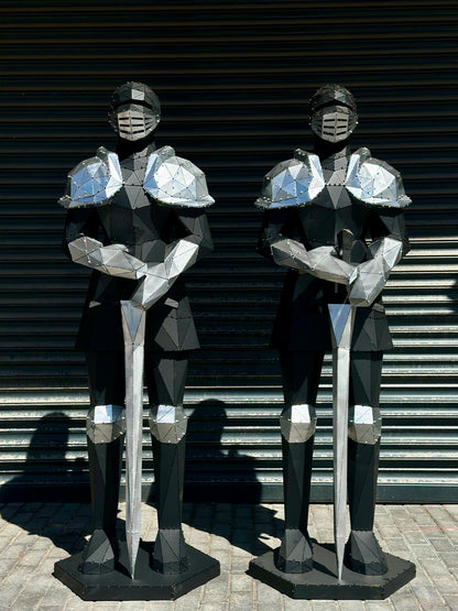 Two modern geometric metal knight sculptures holding swords against a shuttered background.